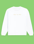 A white crewneck sweatshirt with 'Wear the Wild' printed in a light beige font on the chest, displayed against a solid light green background.