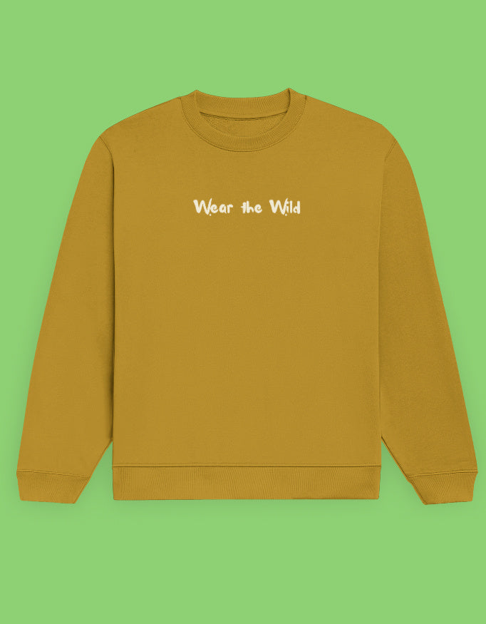 A mustard yellow crewneck sweatshirt with the phrase 'Wear the Wild' printed in white across the chest.