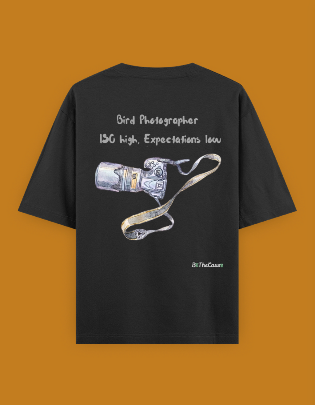 Shop a playful unisex oversized bird photographer t-shirt inspired by birding trips in the Western Ghats. Perfect for birders, wildlife photographers, and nature lovers.

