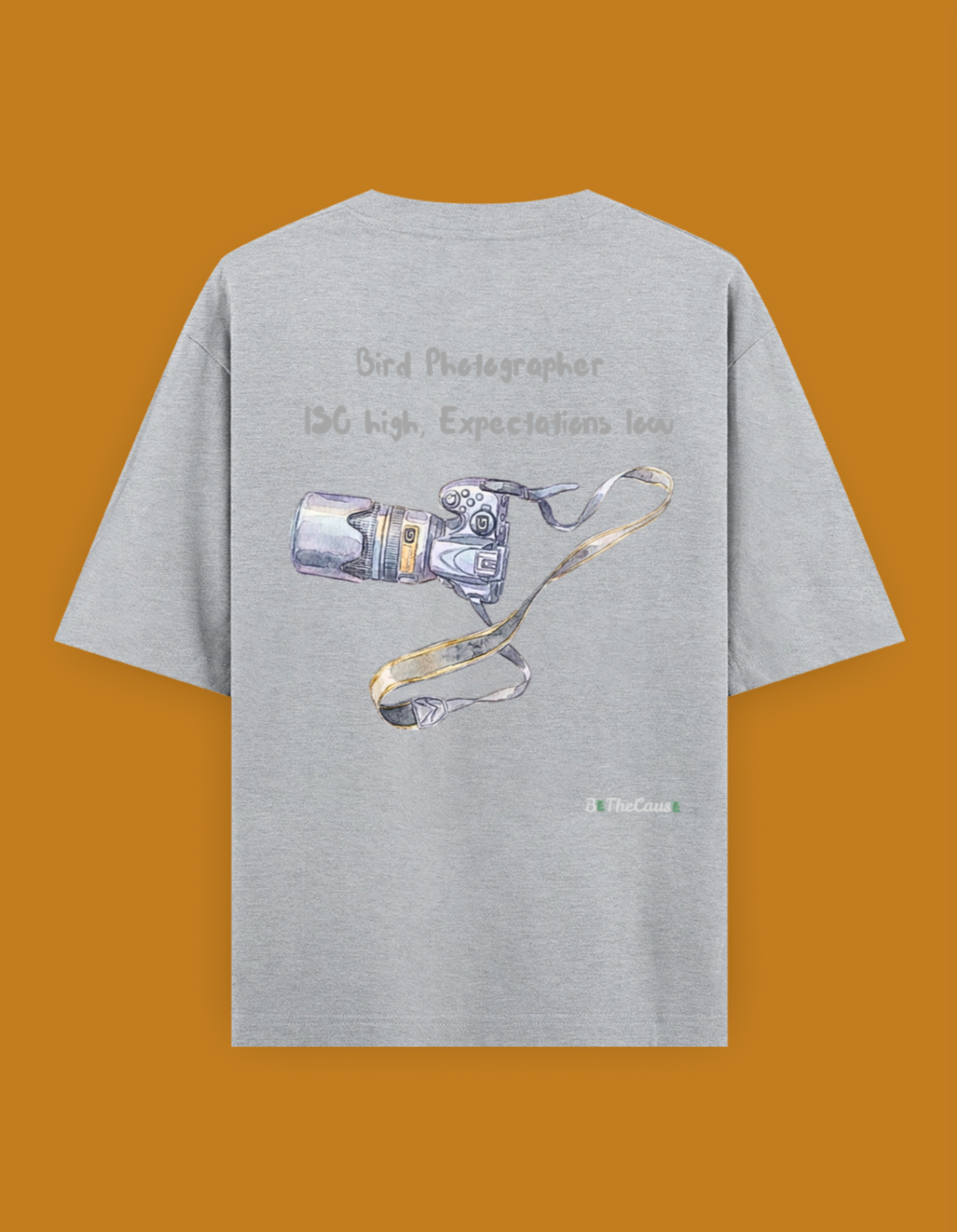 Shop a playful unisex oversized bird photographer t-shirt inspired by birding trips in the Western Ghats. Perfect for birders, wildlife photographers, and nature lovers.
