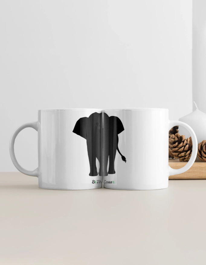 A white ceramic coffee mug with a black silhouette of an elephant 