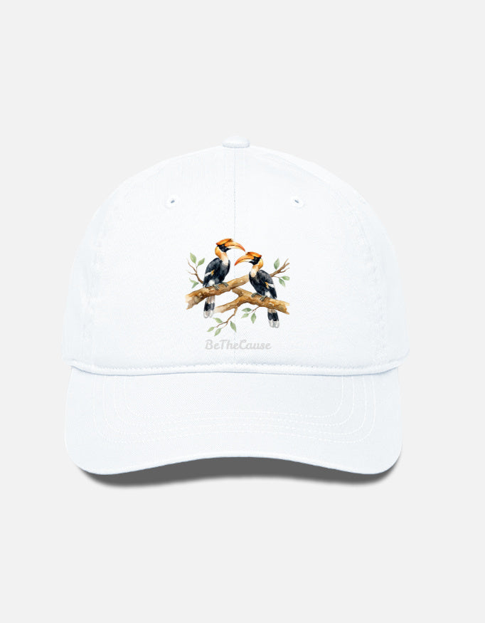 A white baseball cap featuring an embroidered graphic of two Hornbills perched on a branch with the text 'BeTheCause' printed below, set against a light gray background.