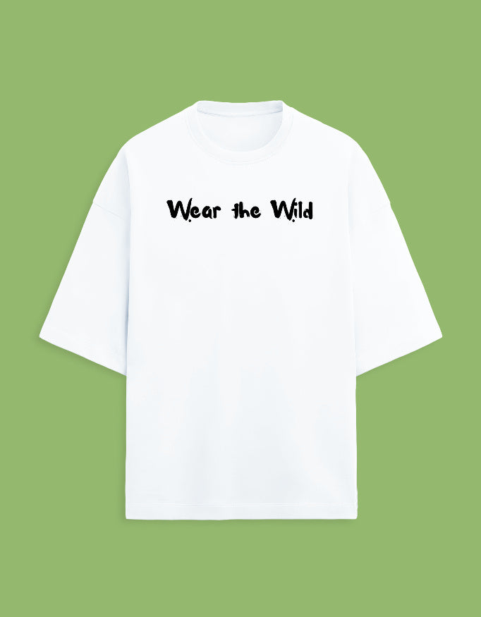 A white short-sleeve t-shirt with the phrase 'Wear the Wild' printed in black across the chest, displayed against a solid light green background.