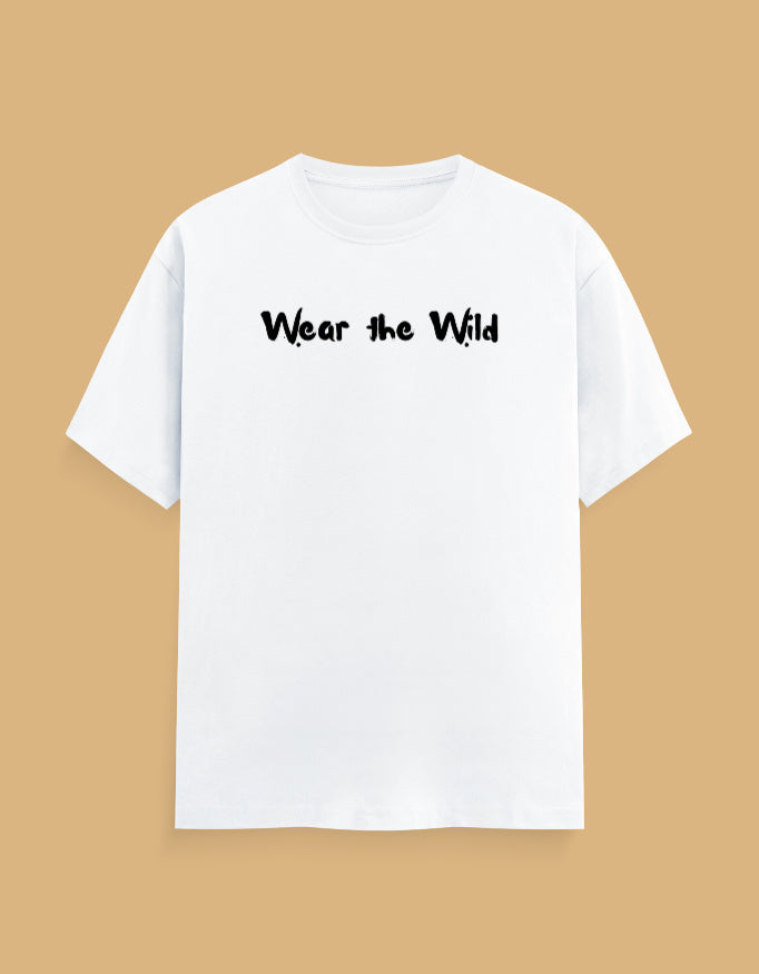 A white short-sleeve crewneck t-shirt with the phrase 'Wear the Wild' printed in black across the chest, displayed against a solid tan background.