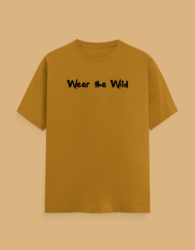 A mustard yellow short-sleeve t-shirt with the phrase 'Wear the Wild' printed in black across the chest, displayed against a solid tan background.