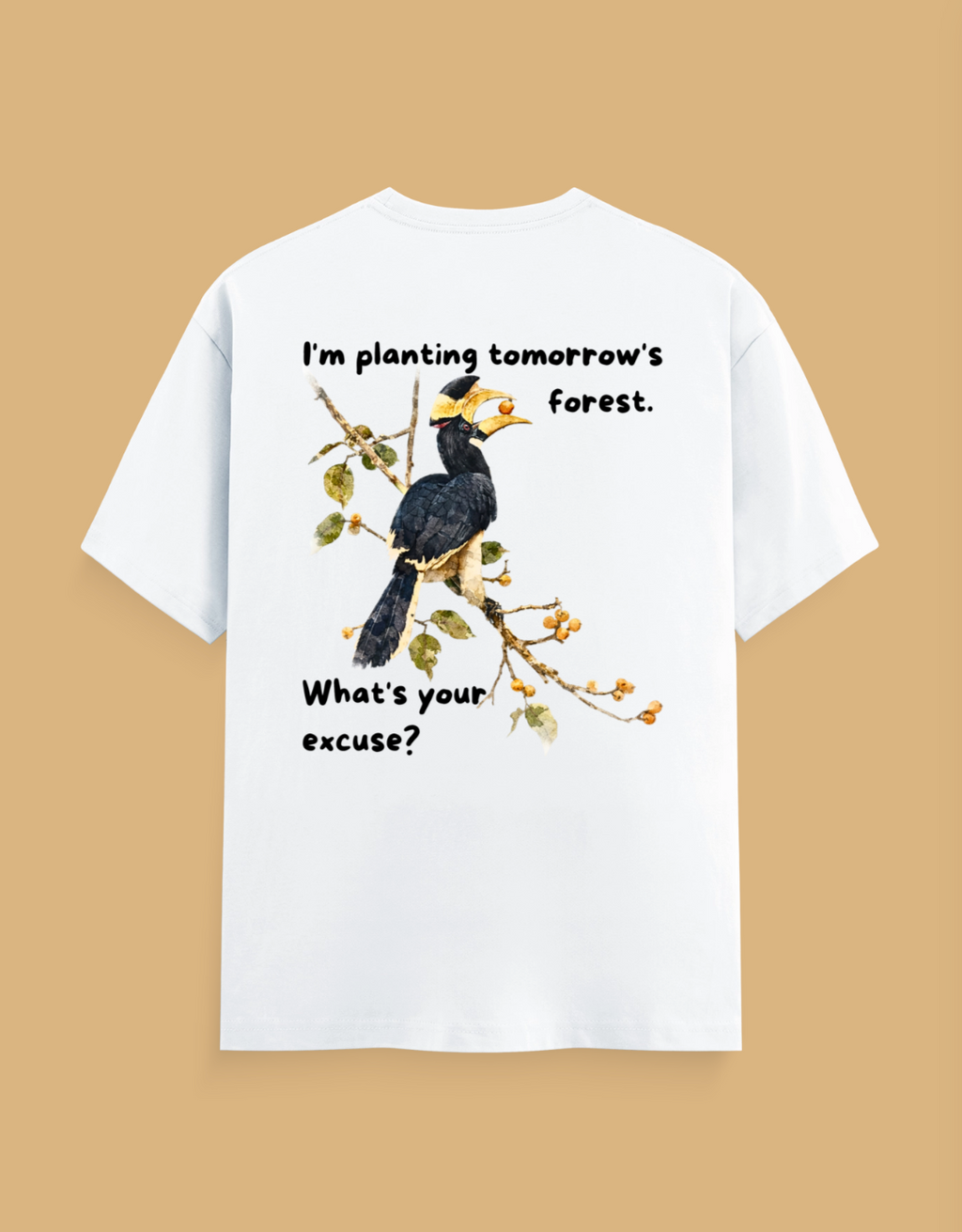A white short-sleeve t-shirt with a graphic print of a hornbill bird on a branch, featuring the text 'I'm planting tomorrow's forest. What's your excuse?' on a solid tan background.