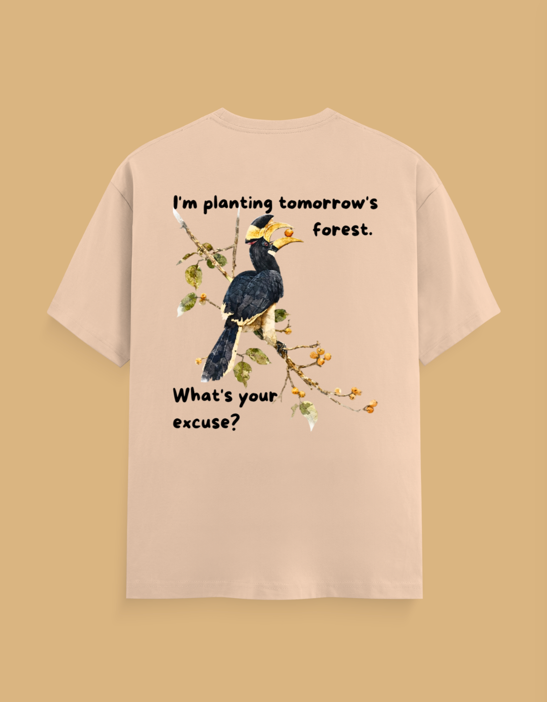 A beige short-sleeve t-shirt shown from the back, featuring a graphic of a black and yellow bird on a branch with the text 'I'm planting tomorrow's forest. What's your excuse?' on a solid tan background.