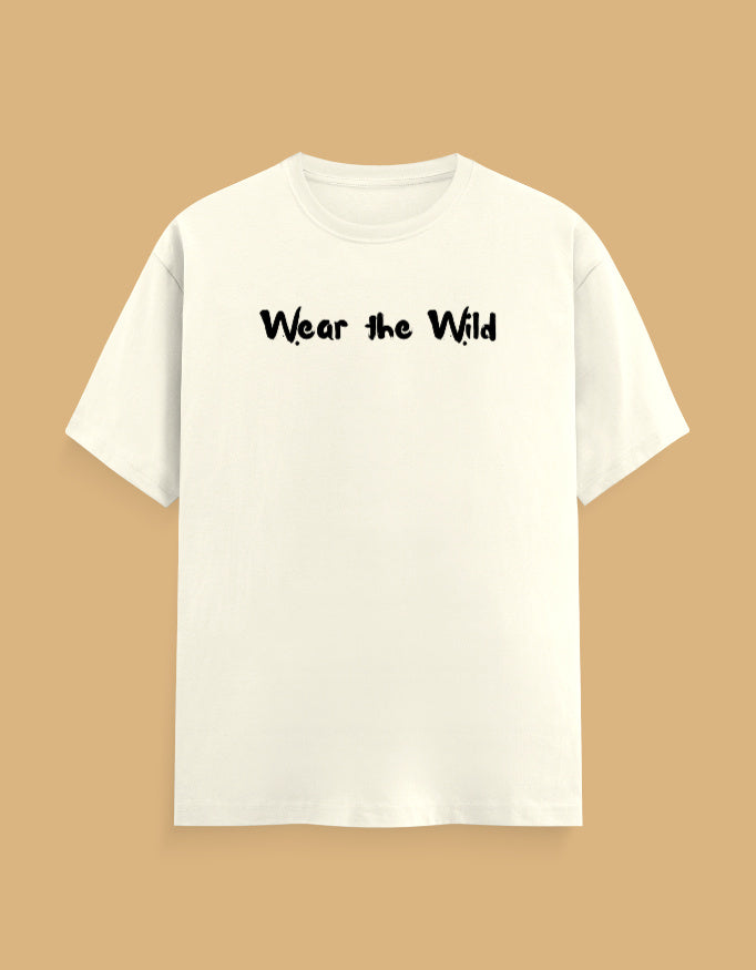 An off-white short-sleeve crewneck t-shirt with the phrase 'Wear the Wild' printed in black across the chest, displayed against a solid tan background.