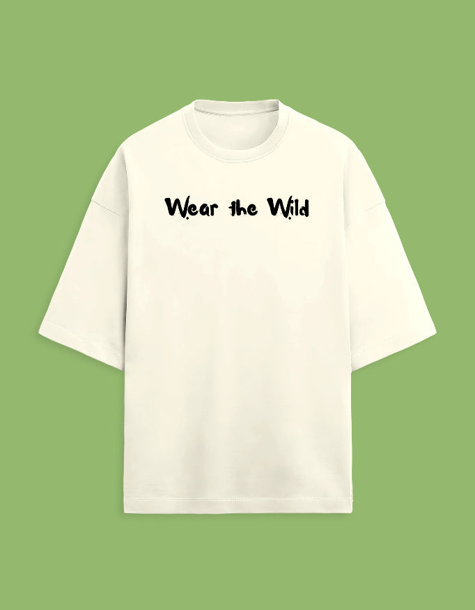 An off-white short-sleeve t-shirt with the phrase 'Wear the Wild' printed in black across the chest, displayed against a solid light green background.